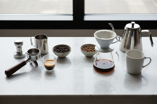 Side-by-side comparison of espresso and pour over coffee brewing setups with premium coffee beans and equipment
